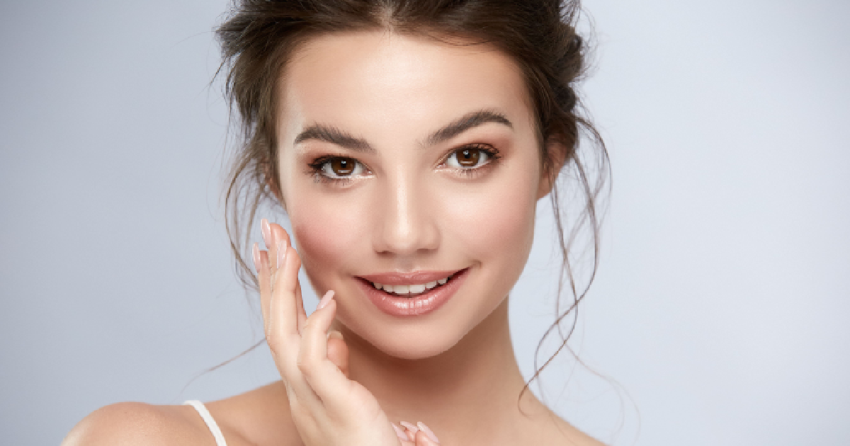 Smiling woman showing radiant, glowing skin after the results of Far Infrared Sauna in Fairfax, VA.