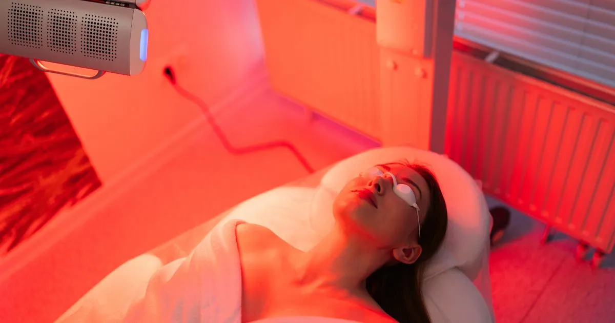 Woman receiving Red Light Therapy facial treatment in Fairfax, VA